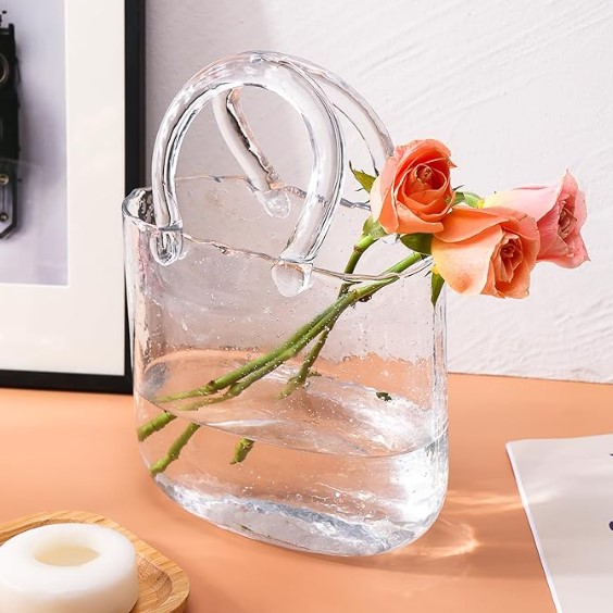 Glass Purse Vase featured in Tailorie's 2024 Holiday Gift Guide For The Girlboss, a unique and elegant glass vase with a handbag shape.